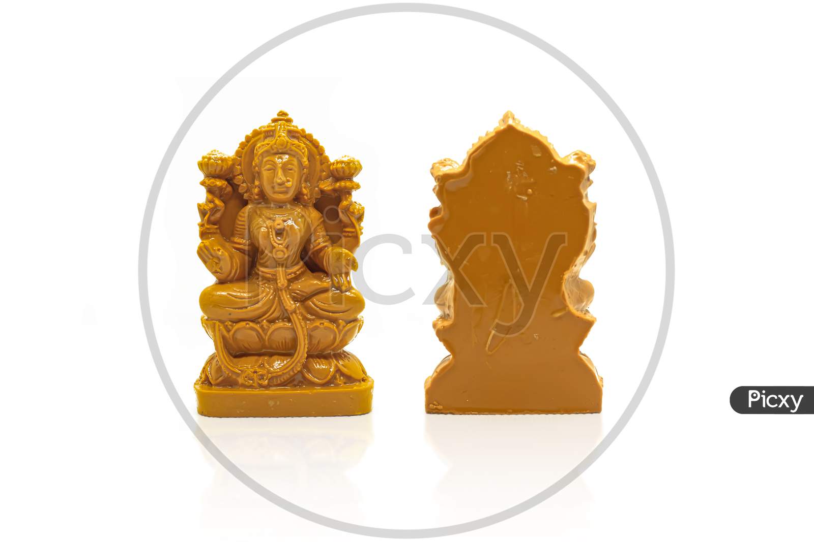 The Statue Of Mahalakshmi Carved In Brown Wood Is Isolated With A White Background With Reflection On The Front And Back.