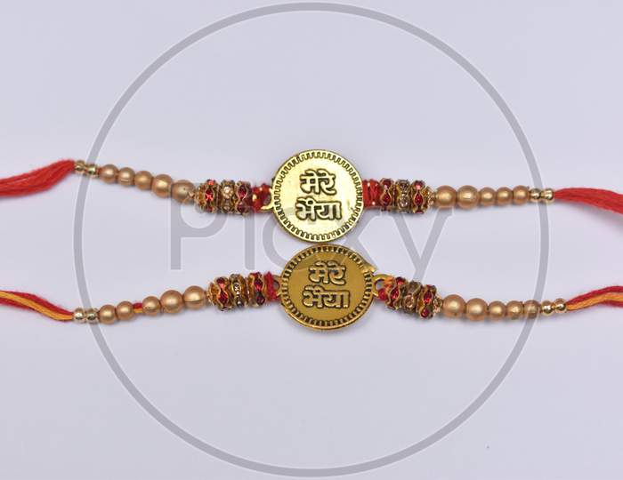 Two Traditional Wrist Band Which Is Symbol Of Love Between Brothers And Sisters On White Background.Raksha Bandhan Celebration