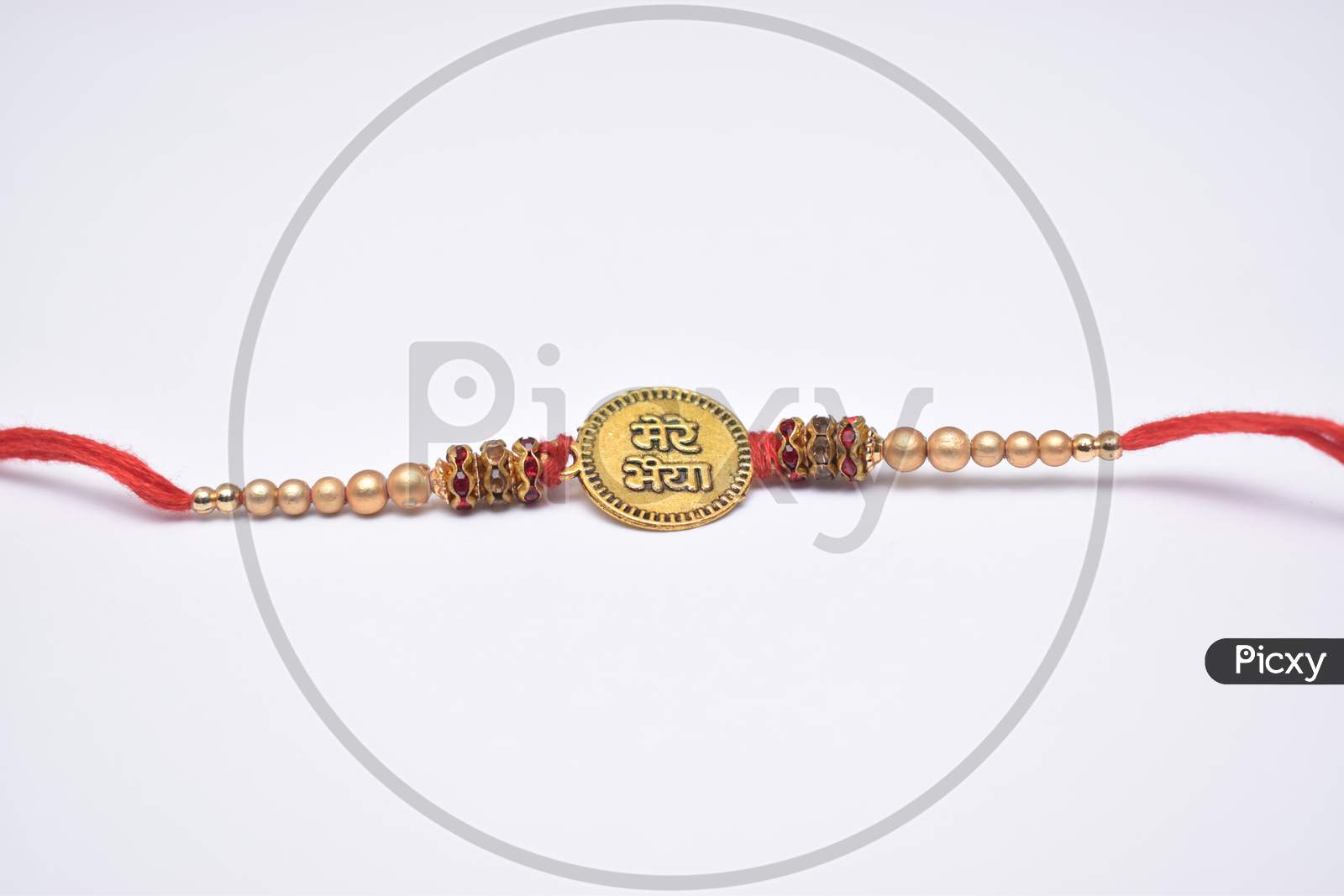 Closeup Shot Of Rakhi With Bhai (Brother) Written On It And Decorated With Beads And Red Thread On White Background