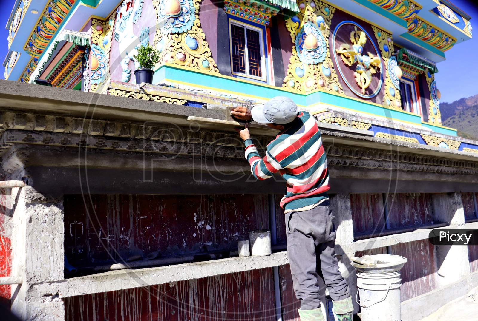 A Mason Doing Art Work On A Monastery Wall,Beautiful Design Made By A Skill Worker