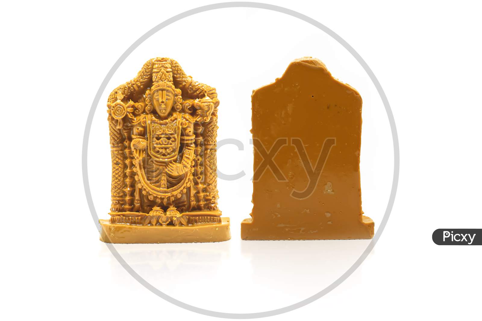 The Statue Of Venkateswara Swamy Carved In Brown Wood Is Insulated With White Reflection On The Front And Back.