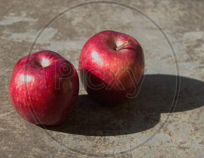 Twin Red Apples On Floor