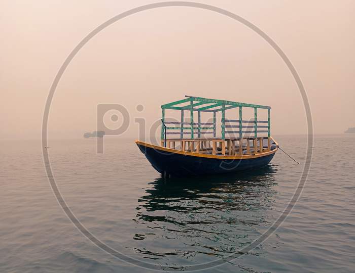 Picture Of A Travel Boat Floating In Deep Water In A Vast Lake