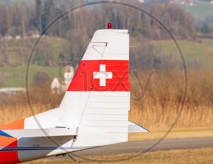 Tail From A As-202 Bravo Airplane With A Swiss Cross On It