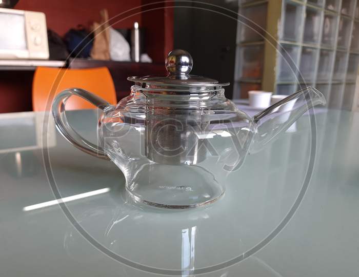 Man Made Glass Jug And Metal Tea Filter Isolated On Table
