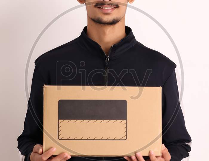 unshaven Indian courier boy with brown box wearing black t-shirt with facial expressions isolated on white background