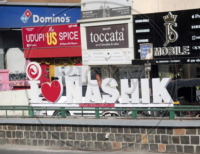 Signage On A Street Crossroad At A Busy City Intersection At College Road, Nashik City Displaying Words I Love Nashik