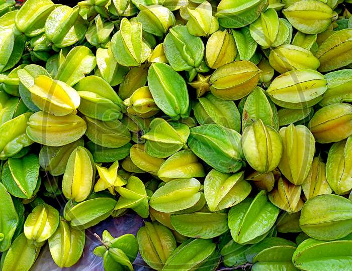Bunch Of Star Fruit Or Carambola To Sell In Local Market. Green And Yellow Color Give The Unique Deliciousness Of This Rare Tropical Fruit