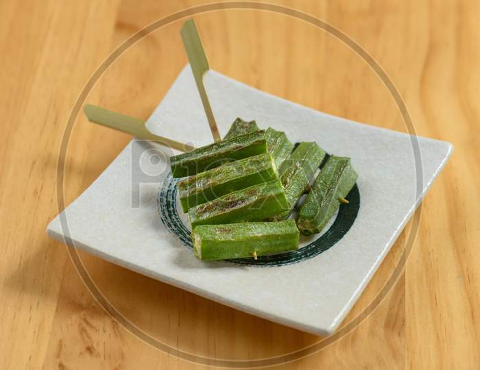Japanese Food Okra In A White Tray Isolated On Wooden Table Top View
