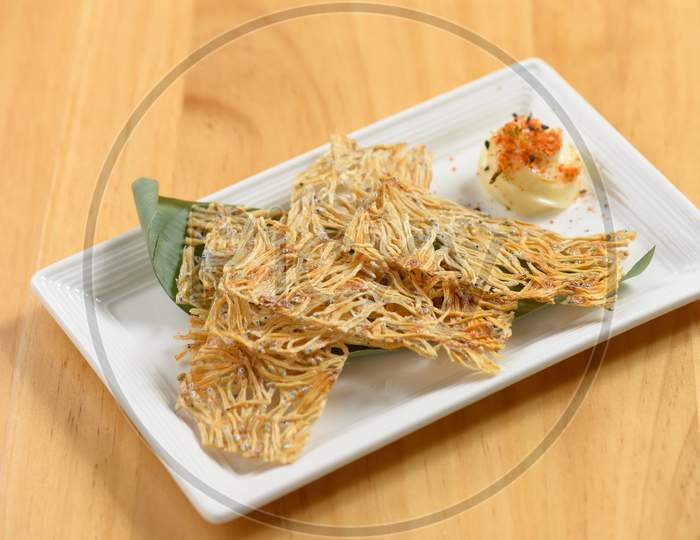 Japanese Food Fried Tatami Iwashi In A White Dish Isolated On Wooden Table Top View
