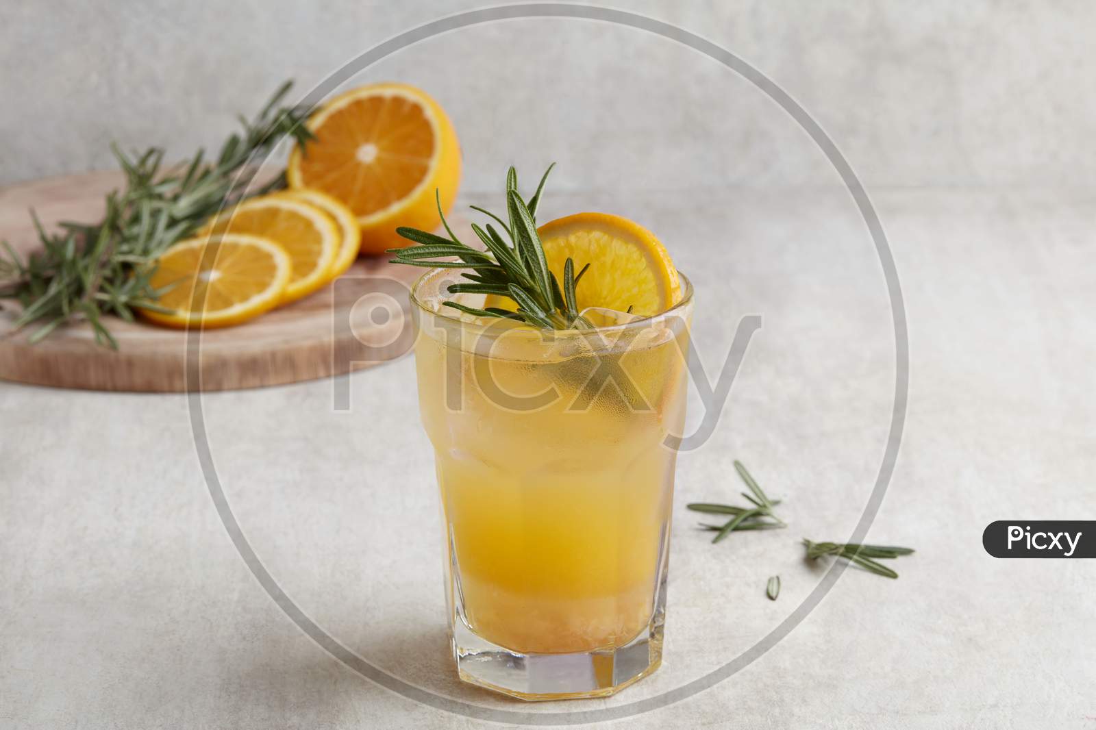 Fresh Summer Orange Cocktail Soda With Lemons, Mint And Ice On Grey Background