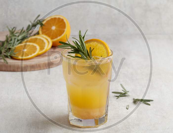 Fresh Summer Orange Cocktail Soda With Lemons, Mint And Ice On Grey Background
