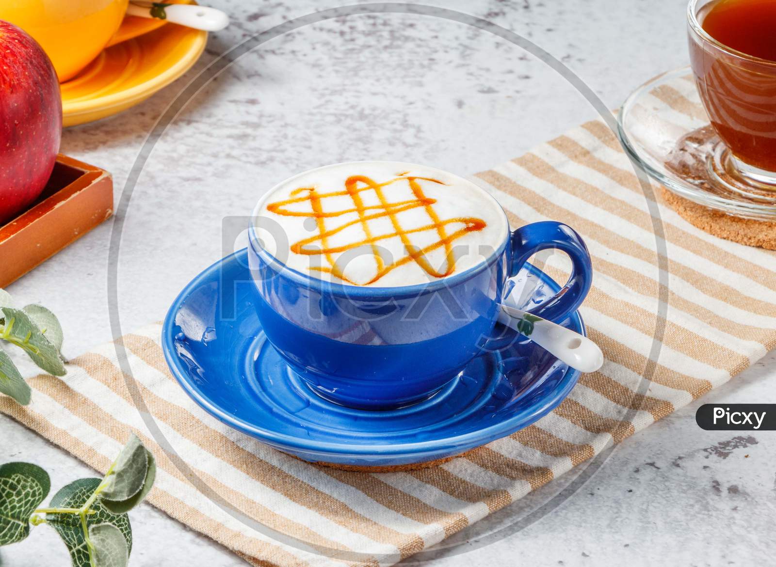 Hot Caramel Macchiato In Blue Cup On Mat With Grey Background Breakfast Drink