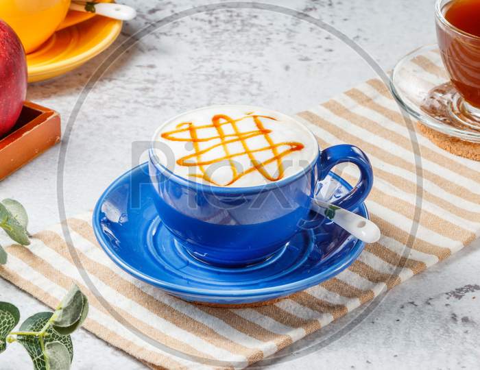 Hot Caramel Macchiato In Blue Cup On Mat With Grey Background Breakfast Drink
