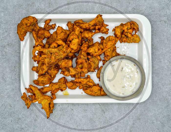 Pakistani Vegetable Pakora With Sauce In White Plate Top View On Grey Background Iftar Food