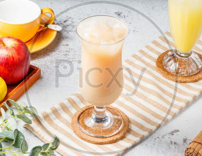 Fresh Grapefruit A Lot Iced Tea In A Glass Jar On Mat And White Background. Fresh Healthy Drinks Concept