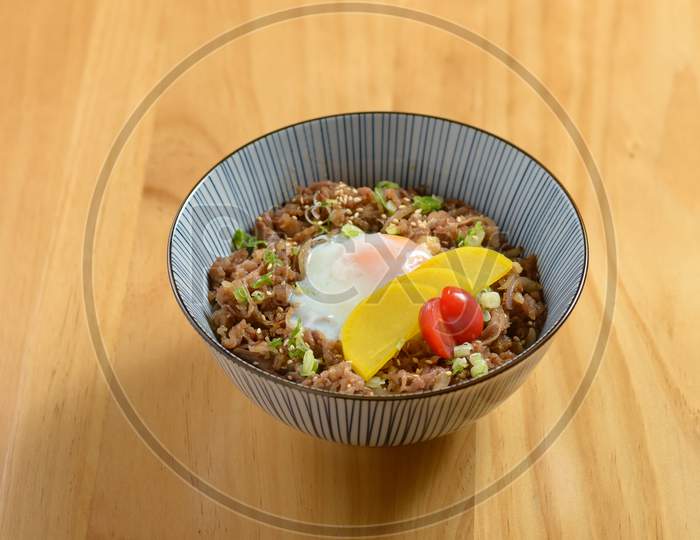 Tasty Beef Gyudon With Fried Rice, Egg And Onion In A Bowl On Wooden Background Top View Of Japanese Food