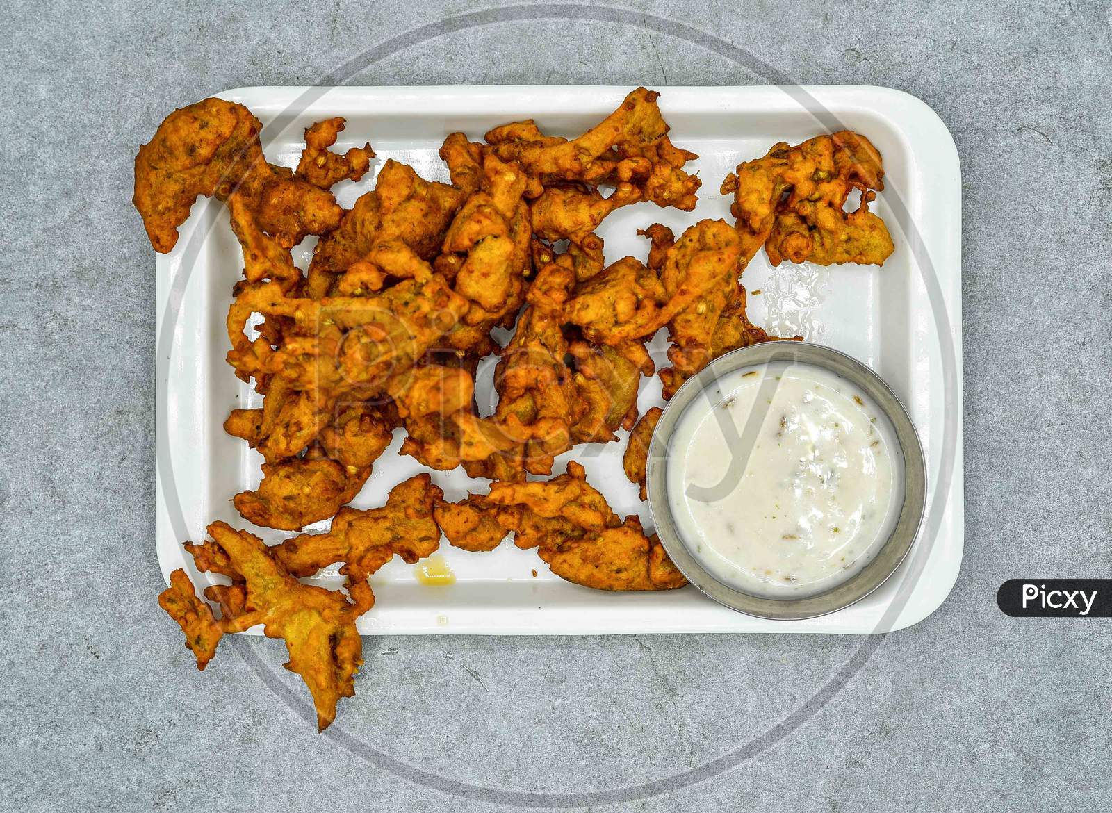 Pakistani Vegetable Pakora With Sauce In White Plate Top View On Grey Background Iftar Food