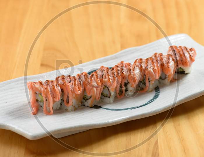 Aburi Sake Mentai Roll With Cheese In White Dish Side View On Wooden Background