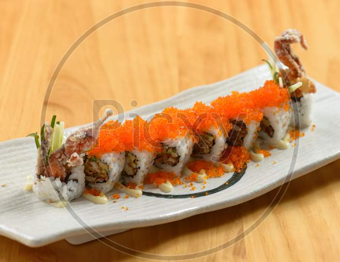 Japanese Food Delicious Spider Maki Roll In A White Dish Isolated On Wooden Table Top View