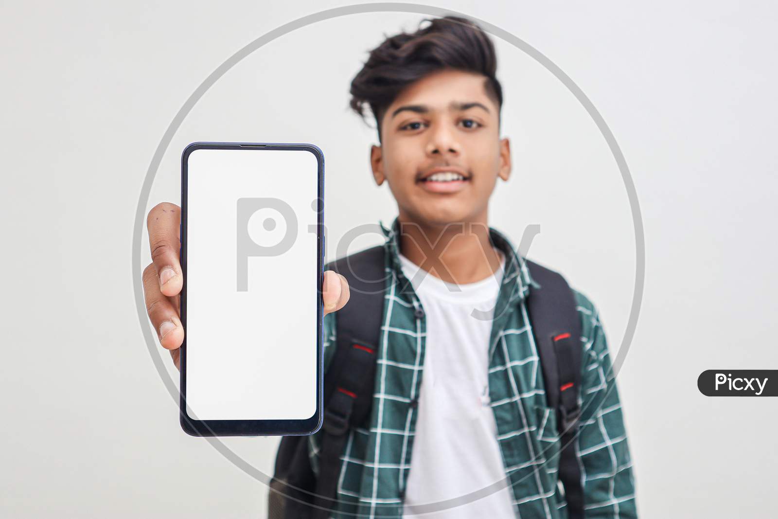 Young Indian College Student Showing Smartphone Screen On White Background.