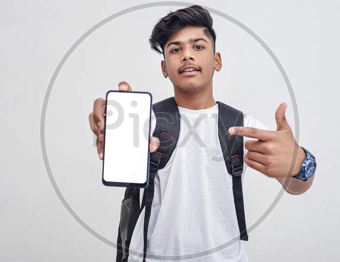 Indian College Student Showing Mobile Screen On White Background.