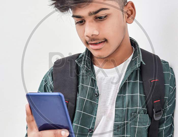Indian College Student Using Smartphone On White Background.