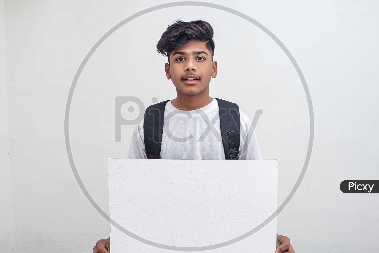 Indian College Student Showing Board On White Background.