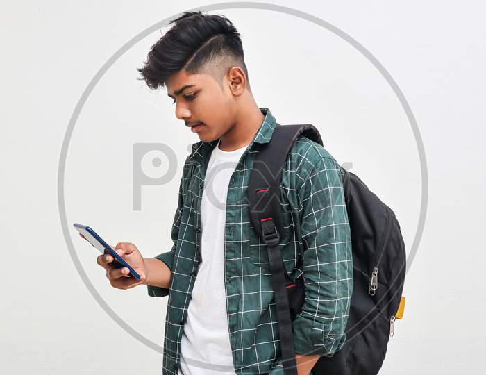 Indian College Student Using Smartphone On White Background.