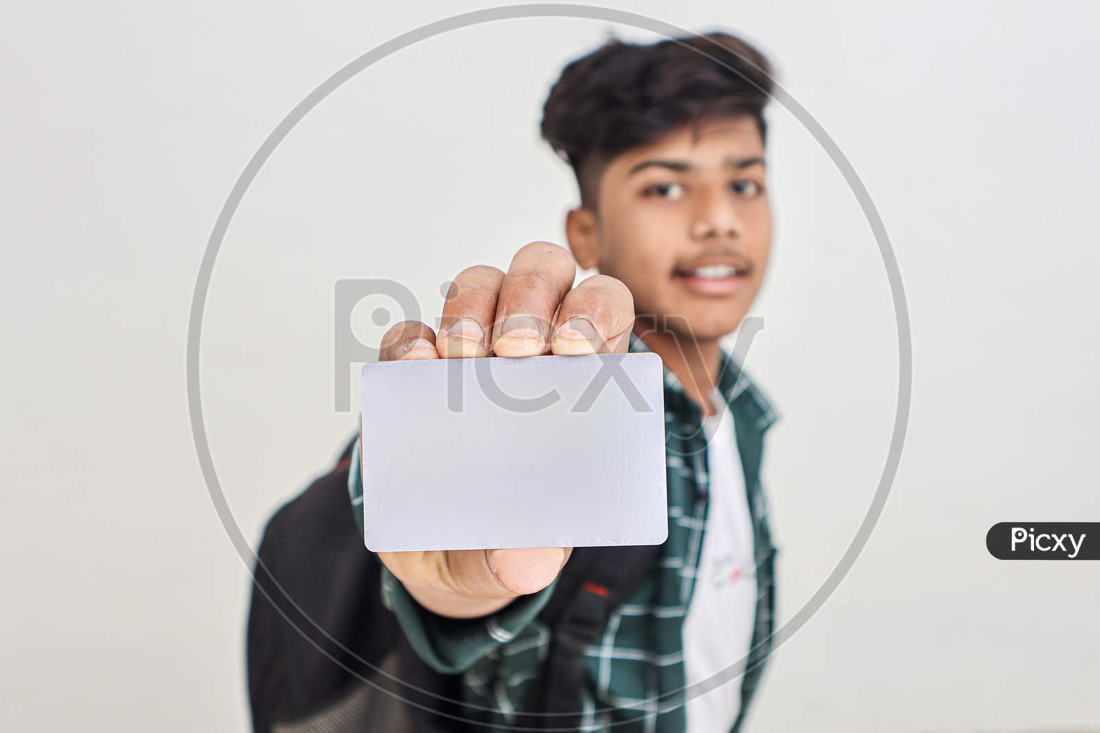 Young Indian Man Showing Debit Or Credit Card On White Background.