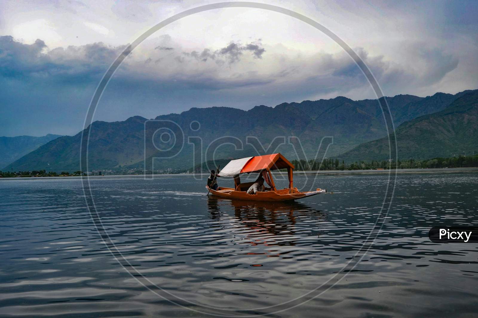 Jammu and Kashmir,Boat in a lake under a cloudy sky