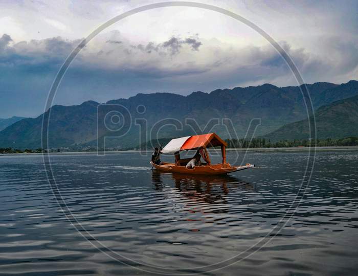 Jammu and Kashmir,Boat in a lake under a cloudy sky