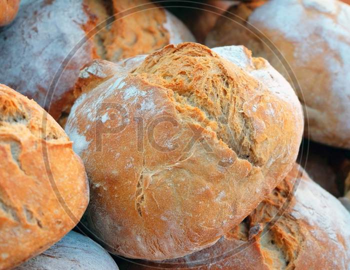 Bread is a staple food prepared from a dough of flour usually wheat and water, usually by baking.